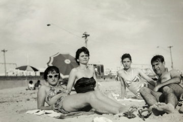 grayscale photo of 3 women sitting on the ground